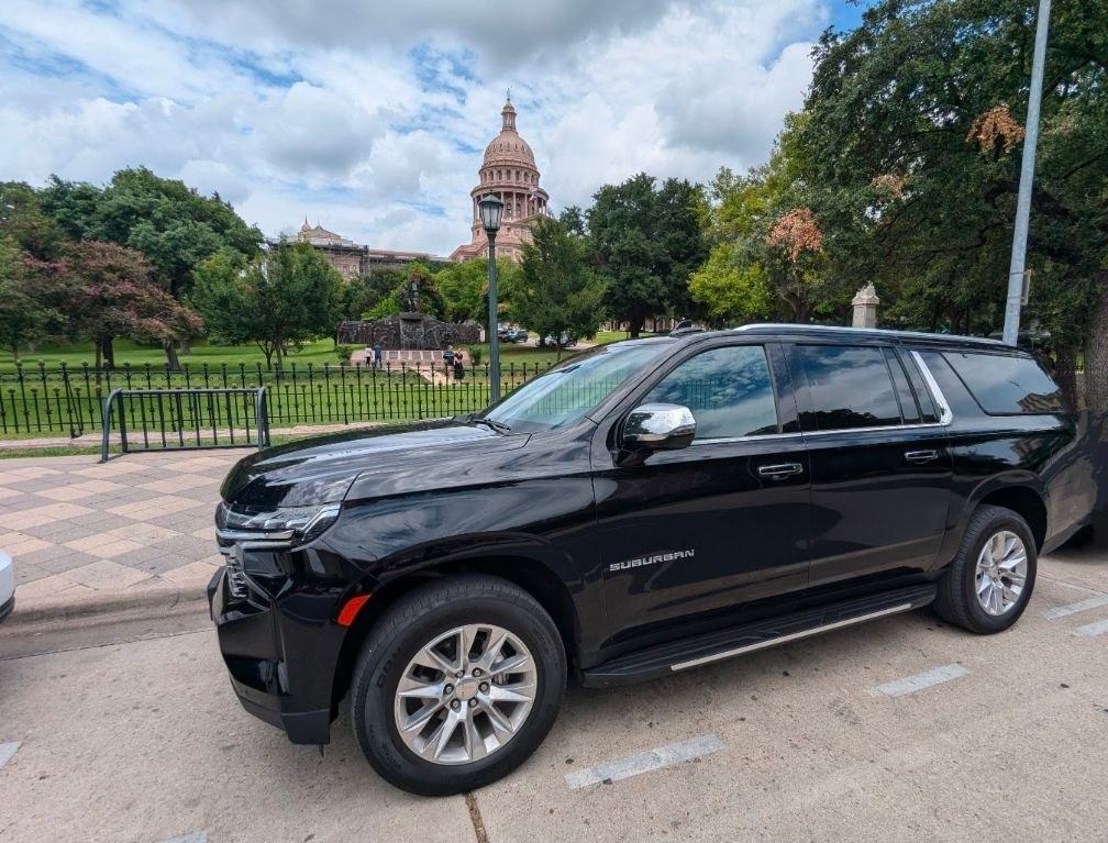 Ubiquitous Driver black Suburban parked at the Texas State Capitol in Austin